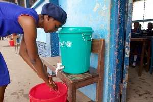 A girl washes her hands, an important prevention.
