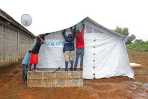 UNICEF team constructing Ebola isolation tent.