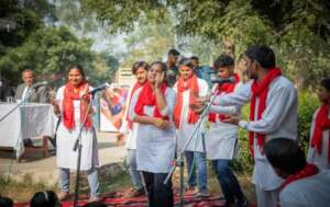 Theatre team performing in front of Community