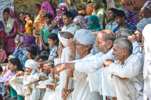 Village leaders watching a street theater event