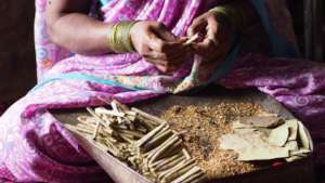 Woman rolls bidi for her daily wage