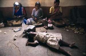 A girl sleeping in the bidi-rolling factory