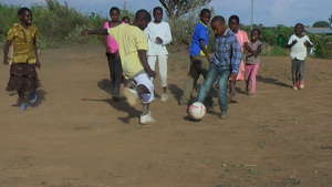 Boys and girls playing football