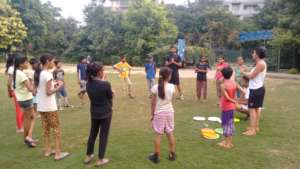Children listen to Frisbee game instructions
