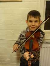 Artus is excited beyond belief to learn the violin