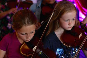 Fiddle players performing in our concert