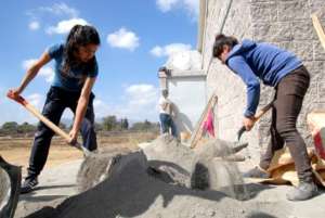 Young women prepare cement in Cerritos