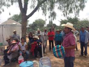 Caminos staff explains the ceramic filter