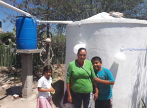 A family celebrates their new rainwater system