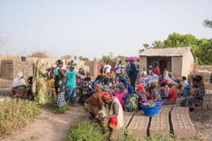 Jaha speaking with a gathering of women.