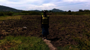 Agatha in front of her newly planted land plot
