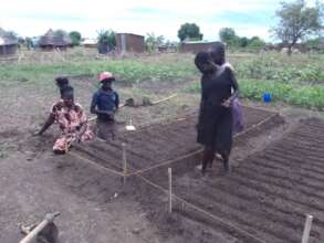 Young teen mothers prepping garden beds