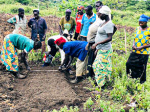 Women prepping a garden in Uganda