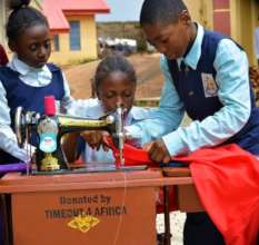 Kids helping each other with the new machine.