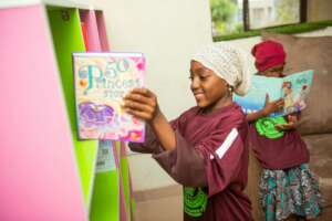 One of our kids helping with placement of books