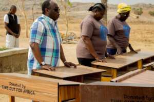 The Bishop and staff saying a prayer