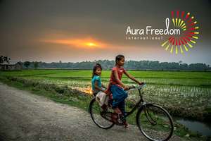 Two girls happily cycling in Nepal.