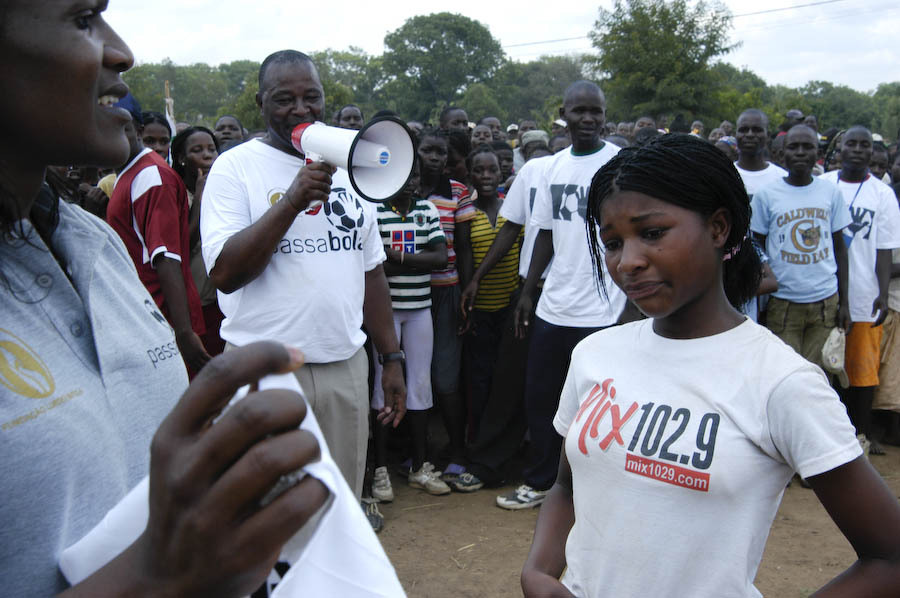 A girl full of emotion receives a prize from Maria