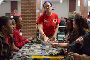 An AmeriCorps Member lead volunteers in service.