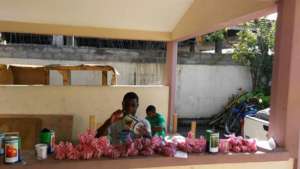 Youth assisting with seed distribution preparation