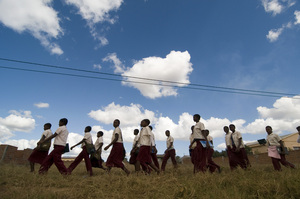 The girls walking to school under the big Magude sky.
