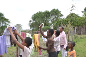 Malel with other rescue girls washing clothes