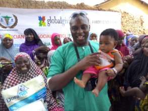 8 month old Hannatu carried by health team member