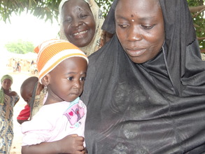 A mother & her child waiting for malaria treatment