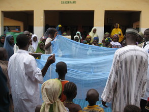 PSJ project team demostrating how to use nets to women in Sahon