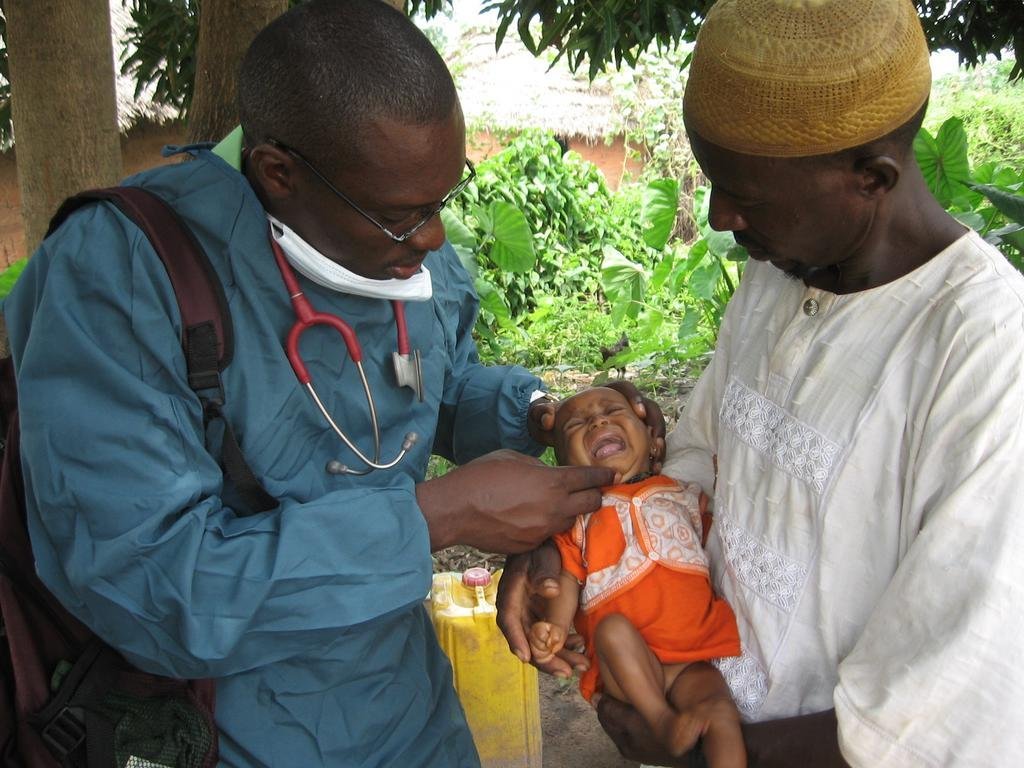 PSJ physician attending to an infant in rural Mash