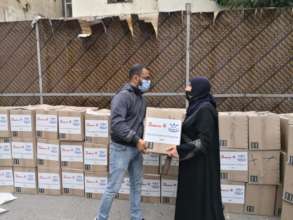 Distributing food kits for female headed household