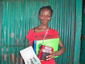 Happy beneficiary receives radio for learning
