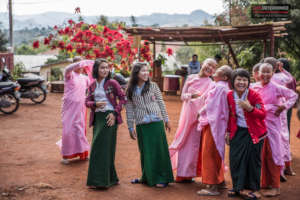 Girls gather by the amazing poinsettia tree