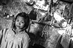 An IDP Kachin girl in her camp home