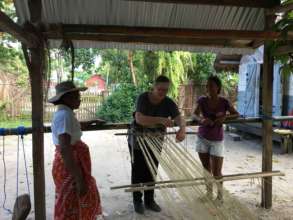 Threading the peddle loom with team