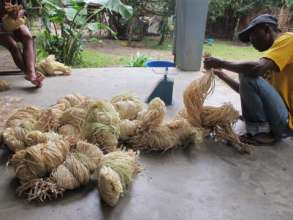 SEPALI team processes raw raffia bundles