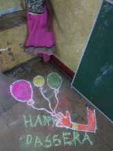 Umang beneficiary displaying her rangoli