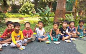 Umang children enjoying snacks at a local garden