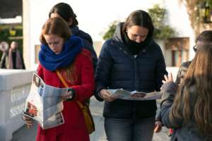 Tourists read campaign information