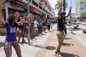 Youth dancing to attract tourists' attention