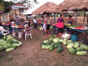 Women farmers sell their crops at the market.