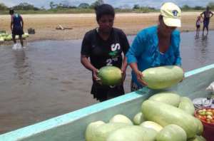 Women load the boats with produce.