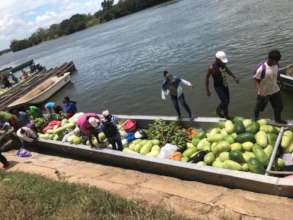 Women load the boat with produce