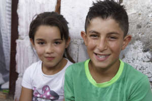 Albina and Mentor in front of their home