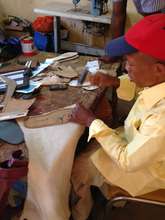 L.O making a pair of shoes at his workshop