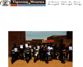 Members at the plot holding letters of thanks