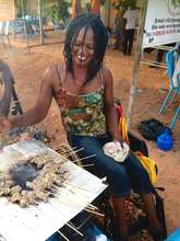 Preparing brochettes for sale at local festival