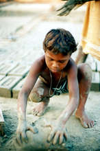 Child making bricks. (Copyright U. Roberto Romano)