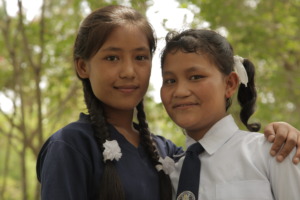 At Sanju's new school, she and Maya have reunited.