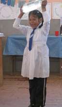 Maria (9) is showing her bottle with safe water